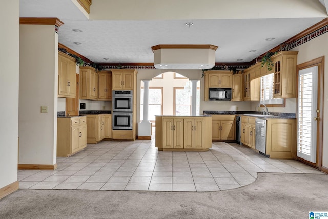kitchen featuring light tile patterned flooring, light colored carpet, dark countertops, and appliances with stainless steel finishes