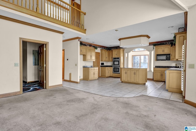 kitchen featuring black microwave, light carpet, double oven, light tile patterned floors, and a towering ceiling