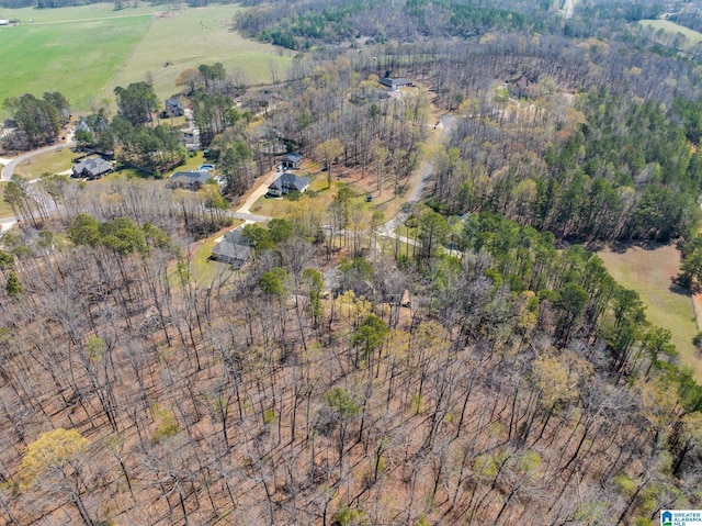 birds eye view of property with a wooded view