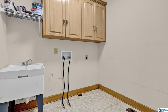 laundry area featuring a sink, hookup for an electric dryer, baseboards, cabinet space, and hookup for a washing machine