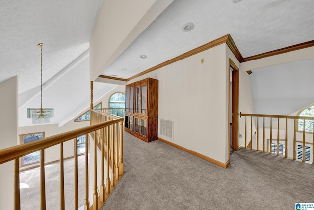 corridor with baseboards, carpet flooring, visible vents, and a notable chandelier