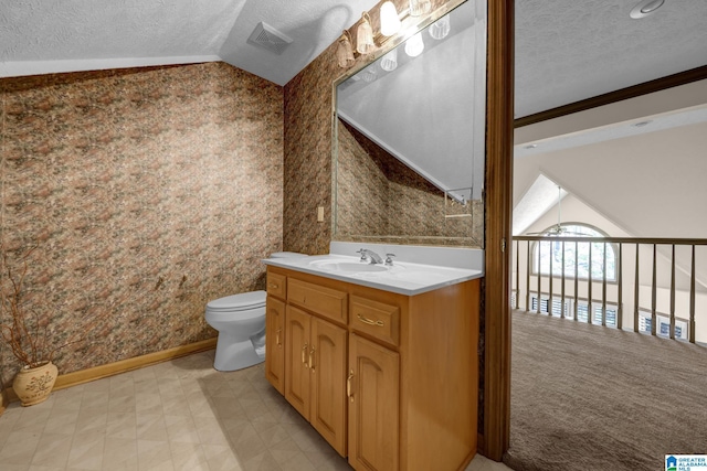 bathroom featuring vaulted ceiling, toilet, vanity, a textured ceiling, and visible vents