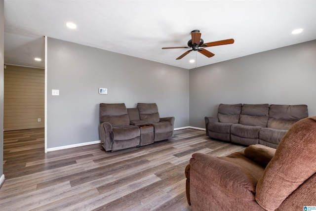 living room featuring a ceiling fan, recessed lighting, baseboards, and wood finished floors