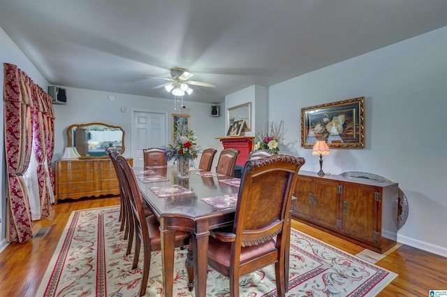 dining area featuring baseboards, visible vents, ceiling fan, and light wood-type flooring
