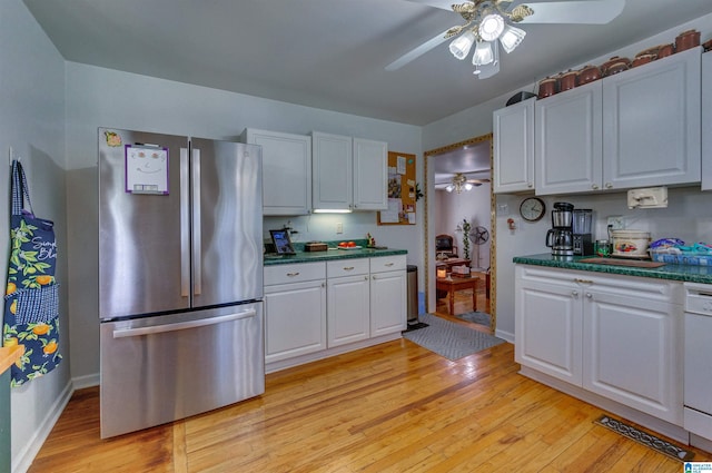 kitchen featuring a ceiling fan, white cabinets, and freestanding refrigerator