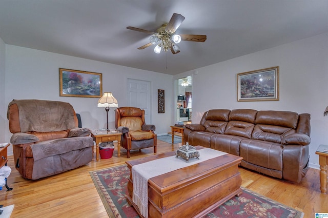 living area with ceiling fan and light wood-style floors