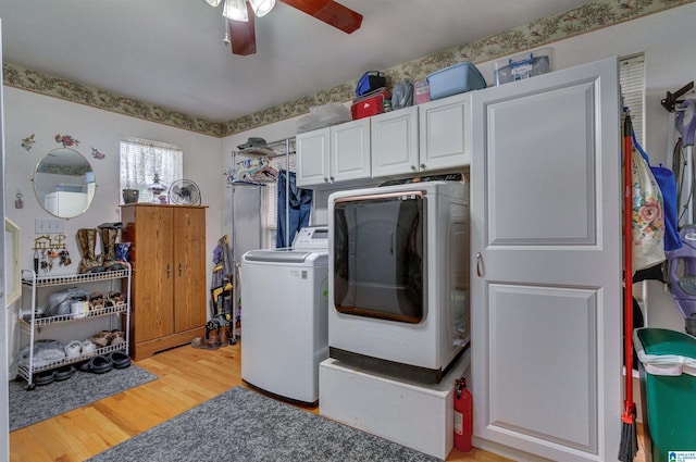 laundry room with light wood-type flooring, washer / dryer, a ceiling fan, and cabinet space