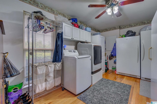 washroom with light wood-style floors, separate washer and dryer, cabinet space, and a ceiling fan