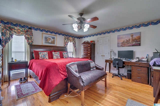 bedroom featuring multiple windows, ceiling fan, and light wood-type flooring