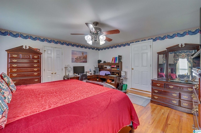bedroom with a ceiling fan, light wood-style flooring, and a closet