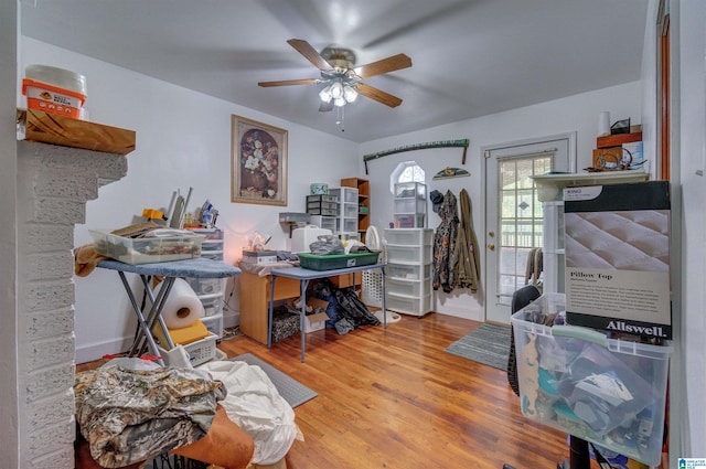 home office with wood finished floors, a ceiling fan, and baseboards