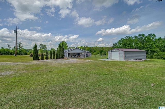 view of yard featuring an outbuilding and a garage