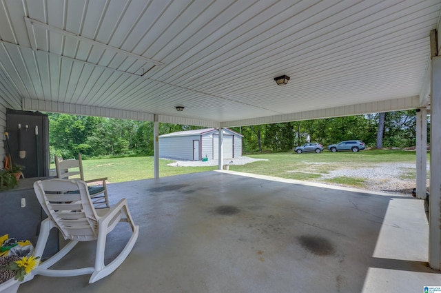 view of patio / terrace with an outdoor structure, a storage unit, and a carport