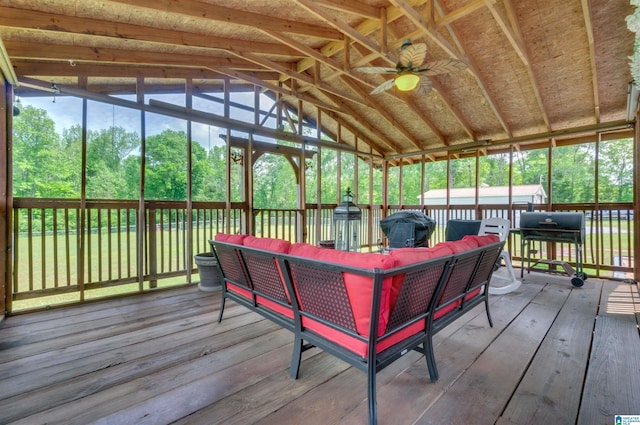 sunroom with a ceiling fan and an outdoor living space