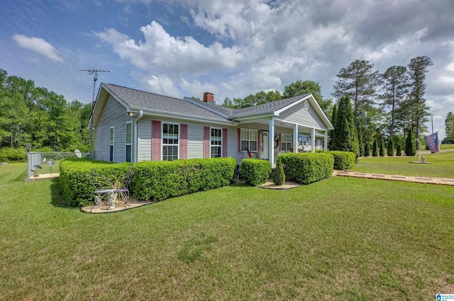 ranch-style house with a front lawn, roof with shingles, and a chimney