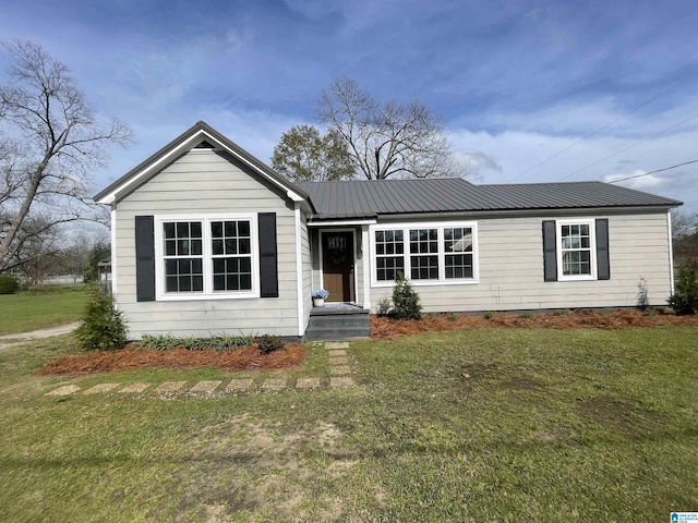 view of front of house with a front lawn and metal roof