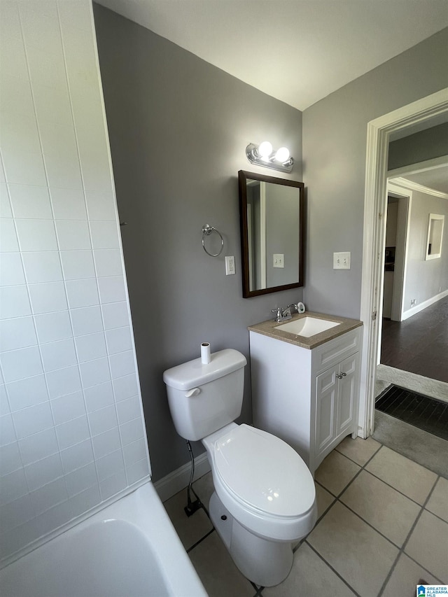 bathroom featuring baseboards, toilet, tile patterned floors, and vanity
