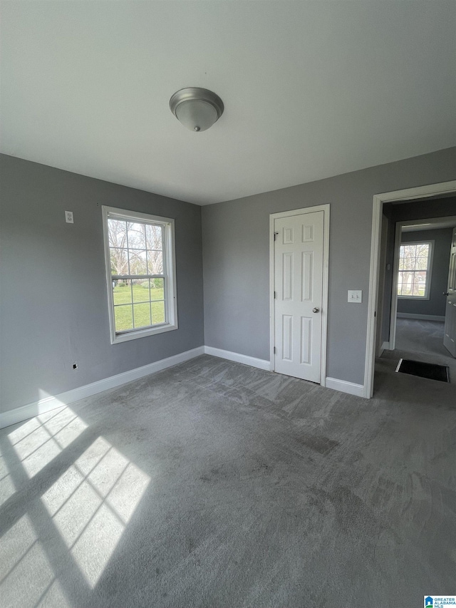 interior space with carpet flooring and baseboards