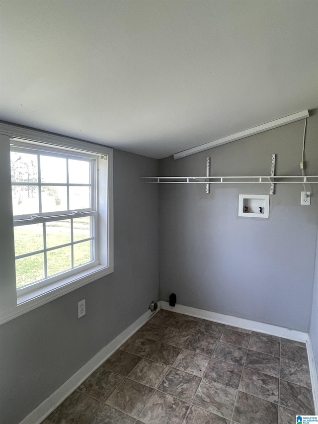 laundry area with baseboards, laundry area, and washer hookup