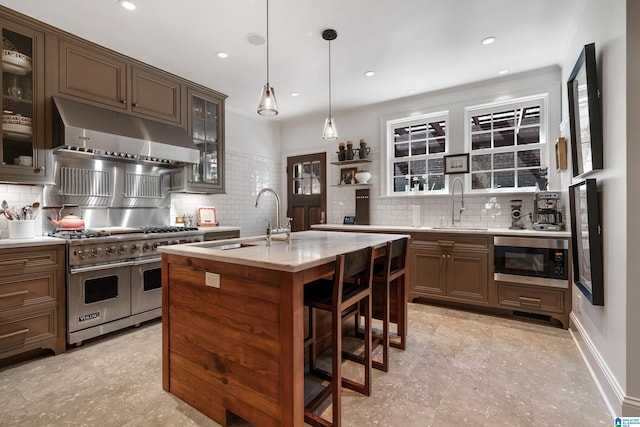 4603 Clairmont Ave, Birmingham, AL 35222 - kitchen with backsplash, a sink, appliances with stainless steel finishes, and under cabinet range hood