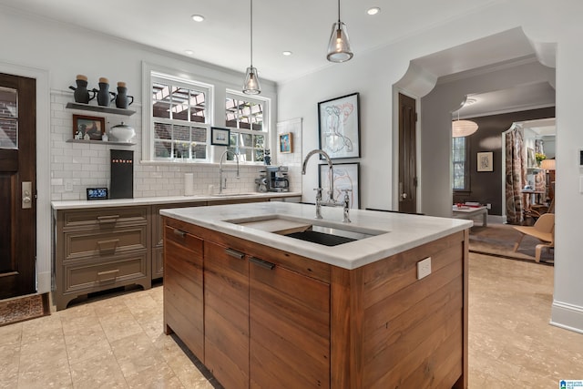4603 Clairmont Ave, Birmingham, AL 35222 - kitchen featuring ornamental molding, a sink, tasteful backsplash, and pendant lighting