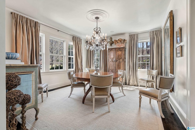 4603 Clairmont Ave, Birmingham, AL 35222 - dining area with baseboards, a notable chandelier, and a healthy amount of sunlight