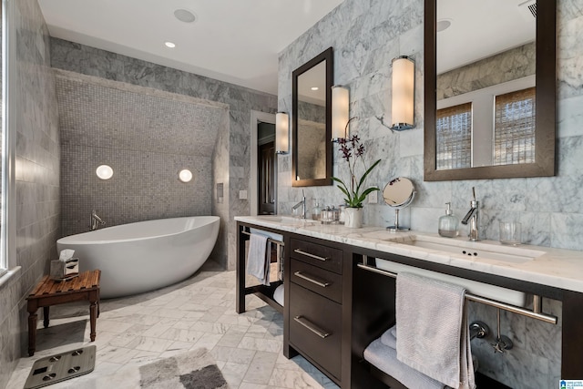 4603 Clairmont Ave, Birmingham, AL 35222 - bathroom featuring tile walls, double vanity, a sink, and a freestanding bath