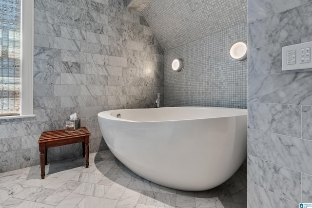 4603 Clairmont Ave, Birmingham, AL 35222 - full bath featuring tile walls, lofted ceiling, a soaking tub, and marble finish floor