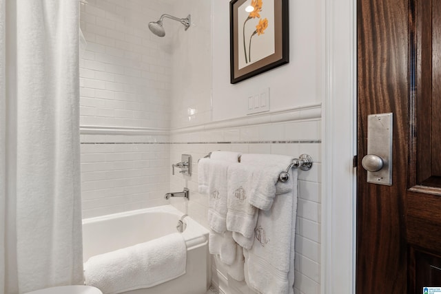 4603 Clairmont Ave, Birmingham, AL 35222 - full bath featuring tile walls, shower / tub combo with curtain, and a wainscoted wall