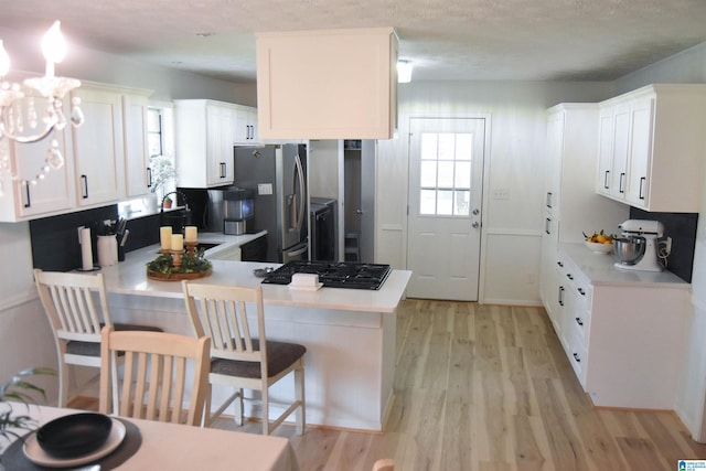 kitchen with white cabinetry, light countertops, stainless steel fridge with ice dispenser, light wood-style floors, and a peninsula