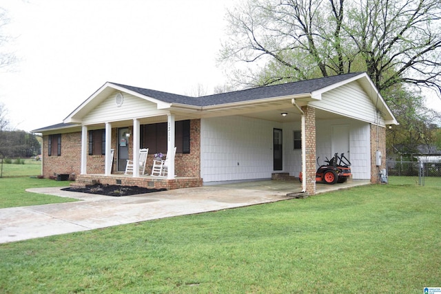 ranch-style home with driveway, a front yard, a carport, and brick siding