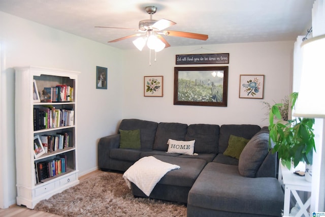 living area with wood finished floors and ceiling fan