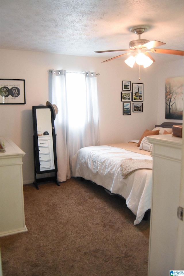 bedroom featuring a ceiling fan, carpet flooring, and a textured ceiling