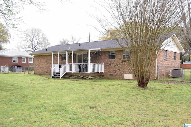 back of property with crawl space, brick siding, a lawn, cooling unit, and a porch