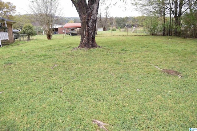 view of yard featuring a fenced backyard and a carport