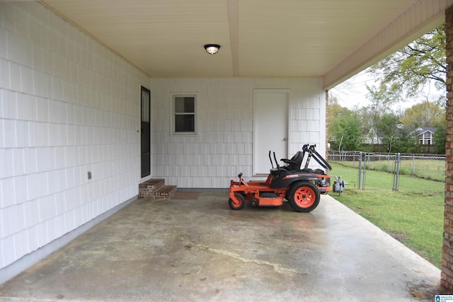 view of patio with an attached carport and fence