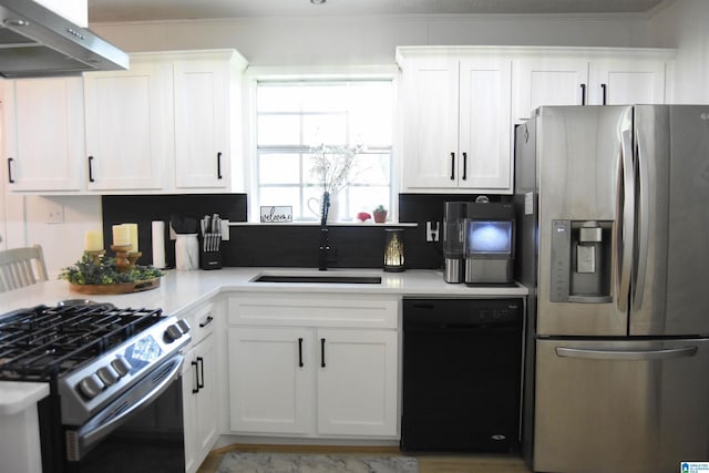 kitchen featuring white cabinets, light countertops, appliances with stainless steel finishes, under cabinet range hood, and a sink