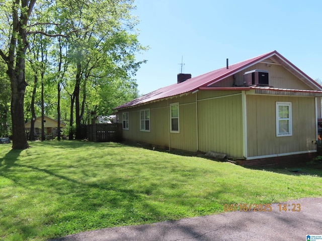 4255 Pulaski St, Birmingham, AL 35217 - view of side of property featuring central AC, fence, a lawn, and a chimney