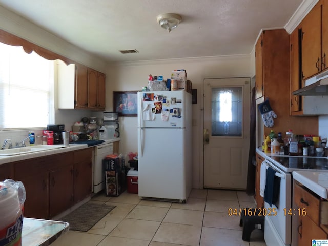 4255 Pulaski St, Birmingham, AL 35217 - kitchen featuring tile counters, white appliances, under cabinet range hood, brown cabinets, and a sink
