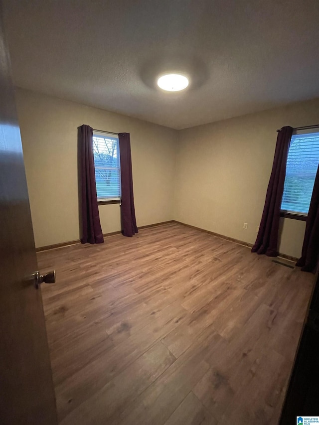 empty room with wood finished floors