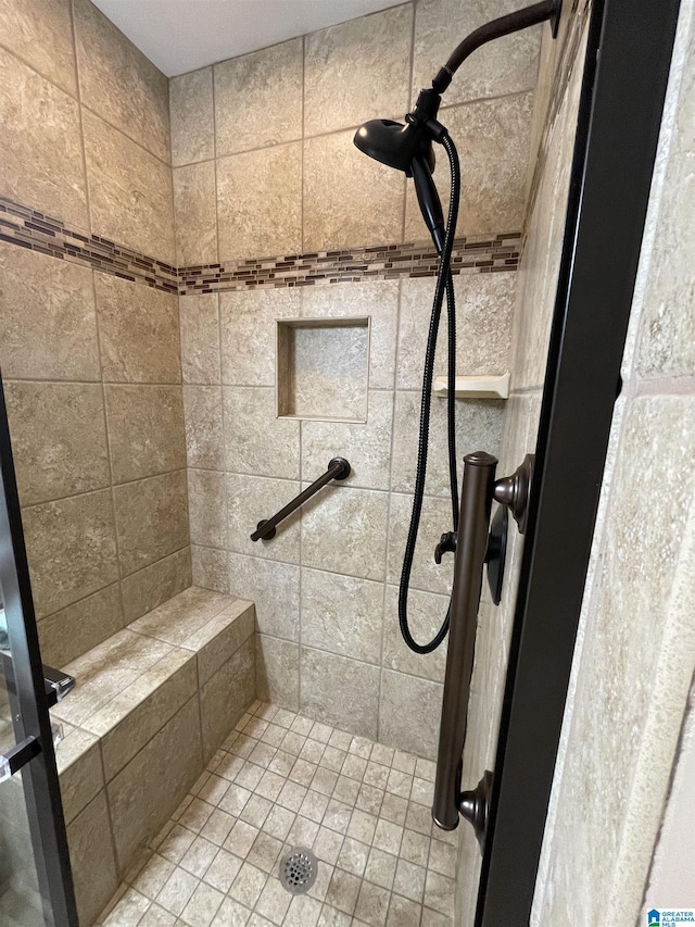 bathroom with tiled shower