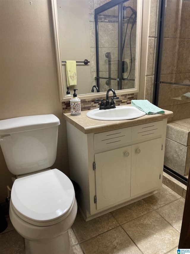 bathroom featuring a shower stall, vanity, toilet, and decorative backsplash