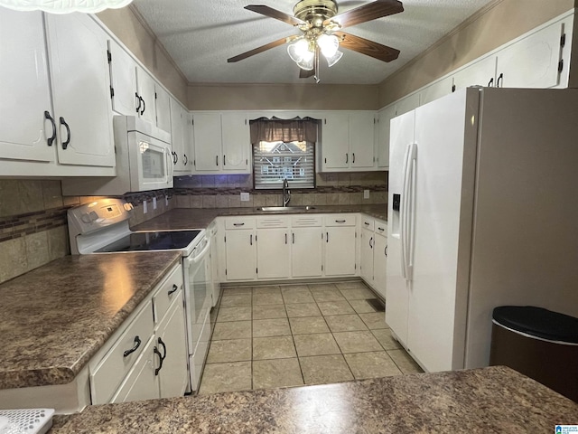 kitchen featuring tasteful backsplash, a sink, white appliances, and dark countertops