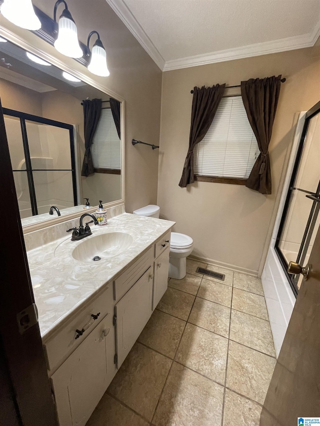 bathroom with crown molding, vanity, visible vents, toilet, and baseboards