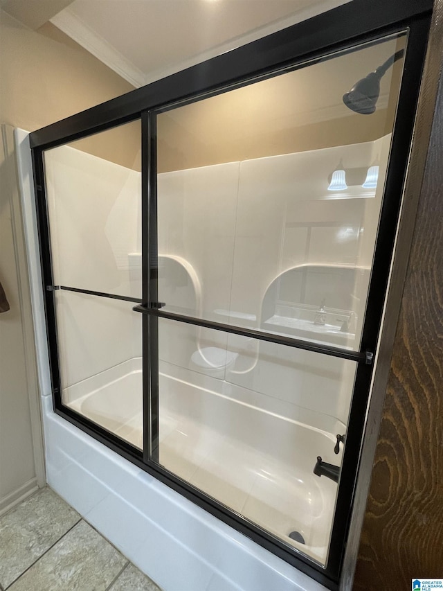bathroom featuring combined bath / shower with glass door, tile patterned flooring, and crown molding