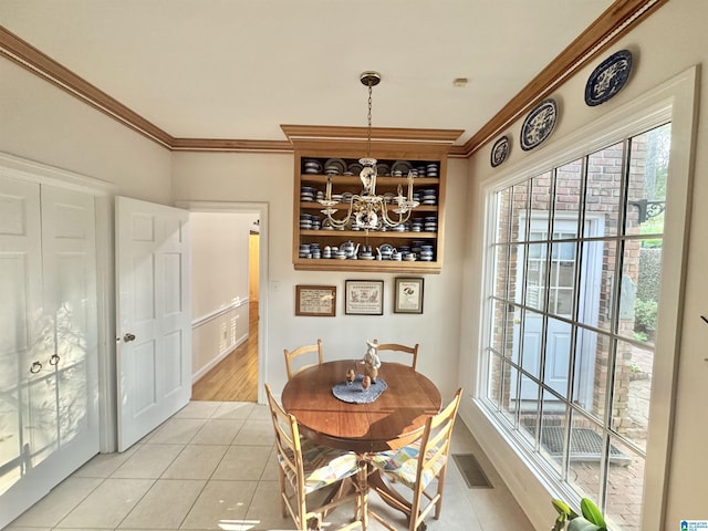 dining area featuring visible vents, light tile patterned floors, ornamental molding, and a chandelier
