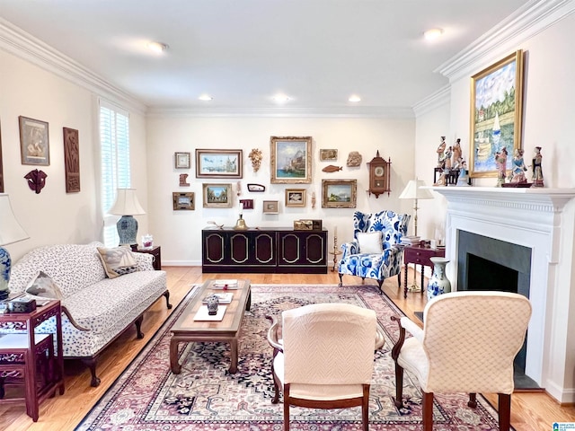 living area featuring light wood finished floors, baseboards, a fireplace, ornamental molding, and recessed lighting