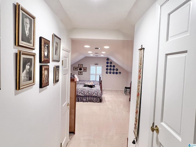 interior space with baseboards, vaulted ceiling, recessed lighting, and light carpet