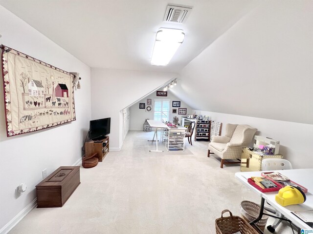 interior space with baseboards, lofted ceiling, visible vents, and carpet