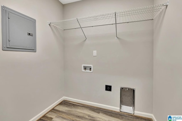 clothes washing area featuring electric panel, electric dryer hookup, laundry area, baseboards, and hookup for a washing machine